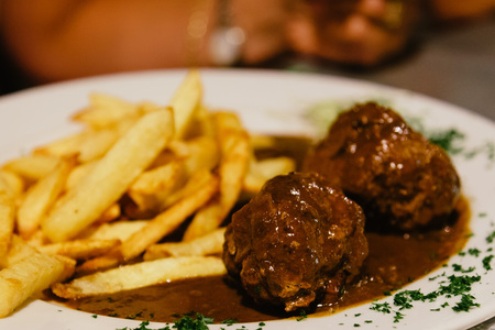 Meatballs with french fries in restaurant in Brusselsの写真素材