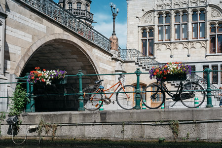 Ghent, Belgium - July 31, 2016: Canal in the historic center of Ghent with picturesque old buildings and bicycles parked in watersideのeditorial素材