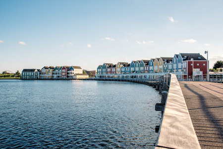 Colorful row houses in Houten, Netherlands, at dusk and reflections on water.のeditorial素材