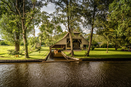 Giethoorn, Netherlands - August 5, 2016: The village Giethoorn is unique in the Netherlands because of its bridges, waterways and typical boats calle punters.  It is also called the Venice of Hollandのeditorial素材