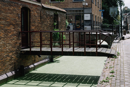 Gouda, Netherlands - August 4, 2016: Picturesque street and canal in the dutch city of Goudaのeditorial素材