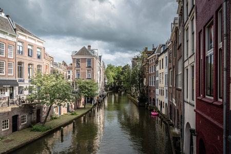 Utrecht, Netherlands - August 4, 2016: Canal in historic centre of Utrecht. Ancient city centre features many buildings and structures several dating as far back as the High Middle Ages.のeditorial素材