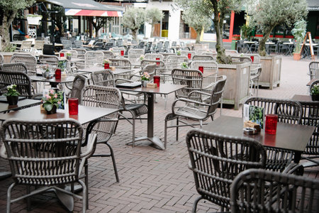 Arnhem, Netherlands - August 09, 2016: Empty sidewalk cafe in a square in the city of Arnhem in...