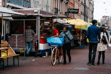 Amsterdam, Netherlands - August 09, 2016 Unidentified people in street market in Oude Pijp neighborhood in Amsterdam a cloudy day of summerのeditorial素材