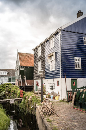 Marken, Netherlands - August 08, 2016. Picturesque traditional houses in Marken. It is known for its characteristic wooden houses and traditional costumes.のeditorial素材