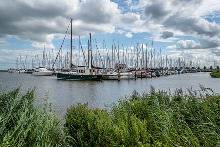 Veolendam, Netherlands - August 08, 2016. Ships moored in the marina of Volendam. Volendam is a popular tourist attraction in the Netherlands, well known for its old fishing boats and the traditional clothing still worn by some residentsのeditorial素材