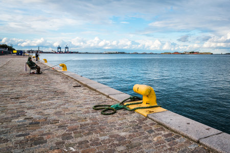 Copenhagen, Denmark - August 10, 2016. Fishermen fishing in the port of Copenhagen near sunset.のeditorial素材