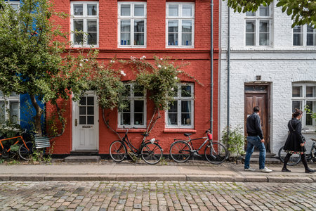 Copenhagen, Denmark - August 12, 2016. Picturesque old brick colorful houses in historical city centre of Copenhagen a cloudy day of summer, with bicycles parkedのeditorial素材