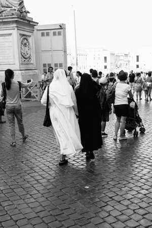 Rome, Italy - August 19, 2016: Two nuns walking on St Peters Square. Black and white picture. The Square is located directly in front of St. Peter's Basilica in the Vatican City and was designed by Berniniのeditorial素材