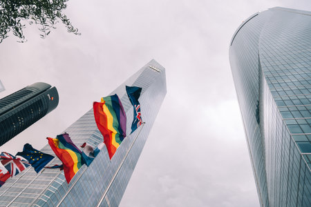 Low angle view of  business district with flags waving on foregrのeditorial素材