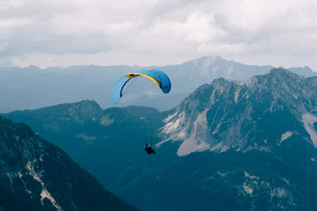Man paragliding on Hoher Dachstein mountainsのeditorial素材