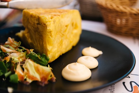 Spanish omelette with mayonnaise in restaurantの写真素材