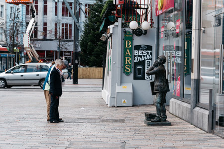 People in front of Statue in St Patrick Street in Corkのeditorial素材
