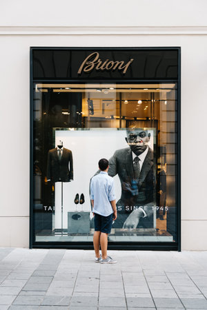 Young man in front of luxury fashion storefrontのeditorial素材