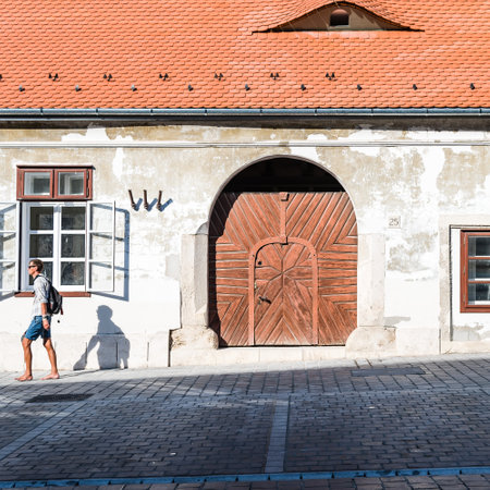Budapest, Hungary - August 12, 2017:  Unidentified man walking at exterior door of residential building in the old city of Buda in Budapest.のeditorial素材