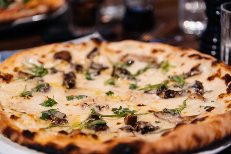 Delicious classic italian Pizza in pizzeriaの写真素材