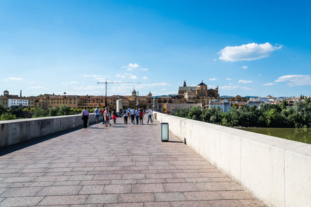 Roman Bridge over Guadalquivir River with Mosque on backgroundのeditorial素材