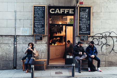 People drinking coffee outside hipster cafe in MalasaÃ±a districのeditorial素材