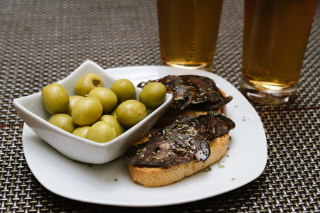 Spanish tapa set with olives and chorizoの写真素材