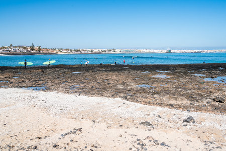 Surfers in the beach of Corralejo Bay