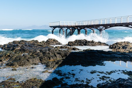 Waves breaking against pier on the beach