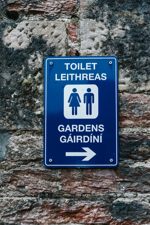 Blue toilet sign on brick wallの写真素材