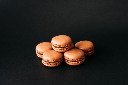 Close up of macaroons isolated on black backgroundの写真素材