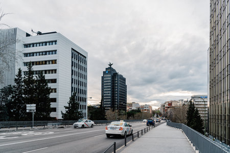 View of financial district in Madrid against cloudy skyのeditorial素材