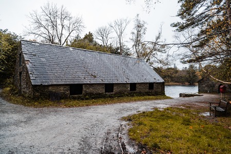 Scenic view of house in forest by lake against sky in Killarney a misty day