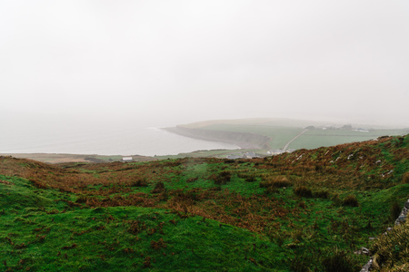 Scenic view of the coast of Ireland a misty dayの写真素材