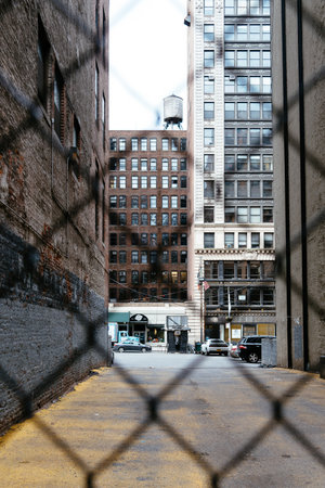 Alley in New York City. View through fenceのeditorial素材