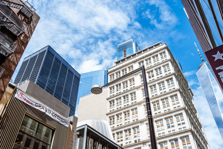 Low angle view of skyscrapers against blue sky in Financial Distのeditorial素材
