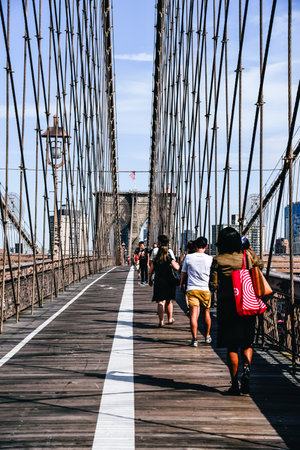 People walking in promenade over Brooklyn Bridge