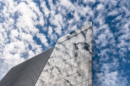 Reflections of clouds against modern skyscraper in New York