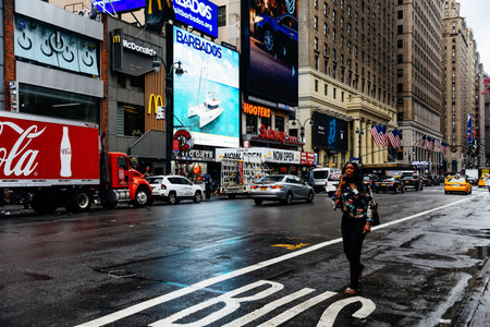 Black woman trying to get a taxi a rainy day in Manhattan.