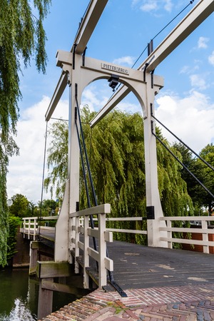Beautiful wooden bridge over canal in The Netherlandsの写真素材