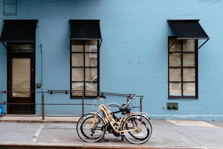 Bicycles parked against blue painted brick facadeのeditorial素材
