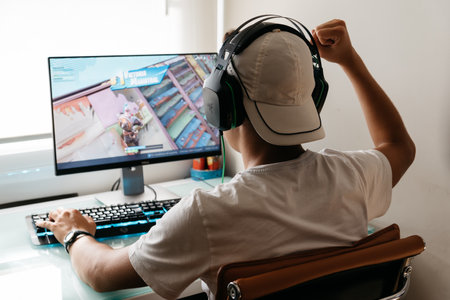 Teenager playing Fortnite video game on PCのeditorial素材