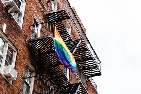Gay rainbow flag waving on balcony in New Yorkの写真素材