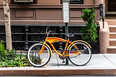 Orange bicycle parked in New York Cityの写真素材