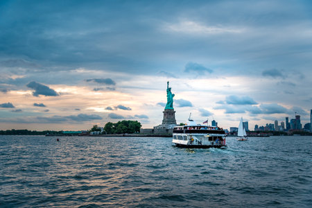Statue of Liberty and Ferry at sunsetのeditorial素材