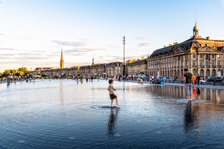 Boy splashing in The Water Mirror in Bordeauxのeditorial素材