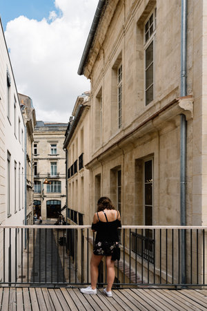 Woman looking down gangway in european cityのeditorial素材