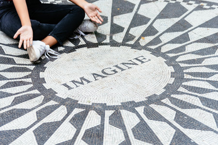 Young woman sitting on the Imagine mosaicのeditorial素材