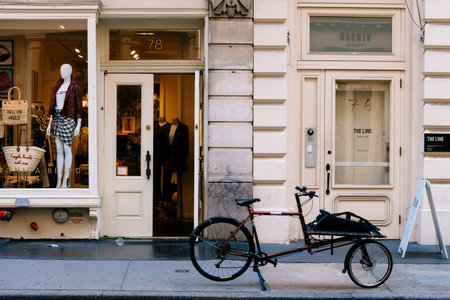 Old bicycle parked at luxury fashion storeのeditorial素材