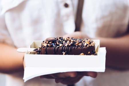 Tasty ice cream bar with chocolate and toppings