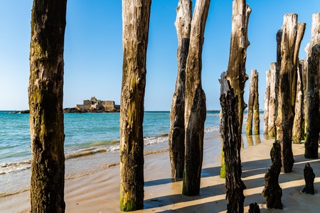 Wooden Poles outside Saint Malo walls at low tideの写真素材