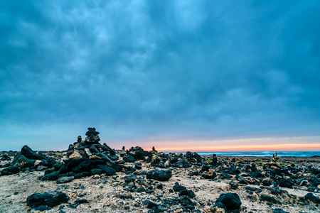Scenic view of rocky beach  at sunsetの写真素材
