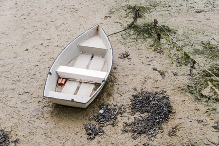 Boat stranded at low tide in the port of Cancale