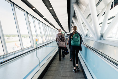 People on moving walkway in the terminal of Airport